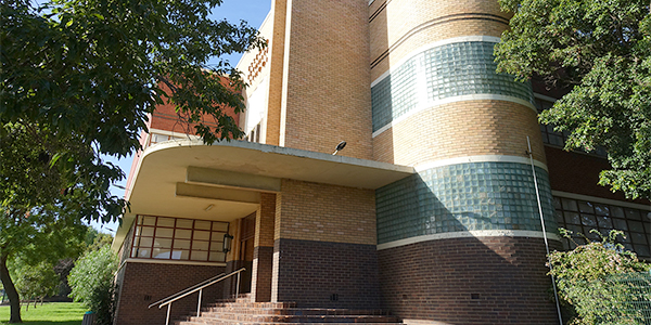 corner of external campus fascade with yellow and red bricks.